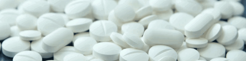 Close-up of white Xanax pills, a commonly prescribed benzodiazepine used to treat anxiety and panic disorders.